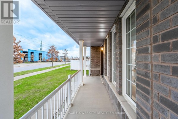 View from the porch showing the walkway and surrounding landscape. - 1 Anderson Road, Brantford