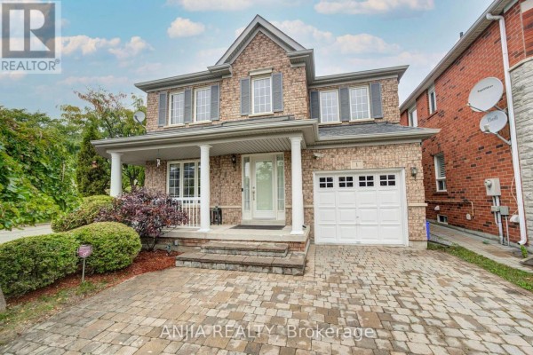 Close-up exterior view of the brick house entrance with a covered porch and white garage door. - 1 Aylesbury Gate, Markham