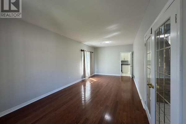 Entrance hall with a staircase, tiled floor, and a view into a living room. - 1 Buman Court, Barrie