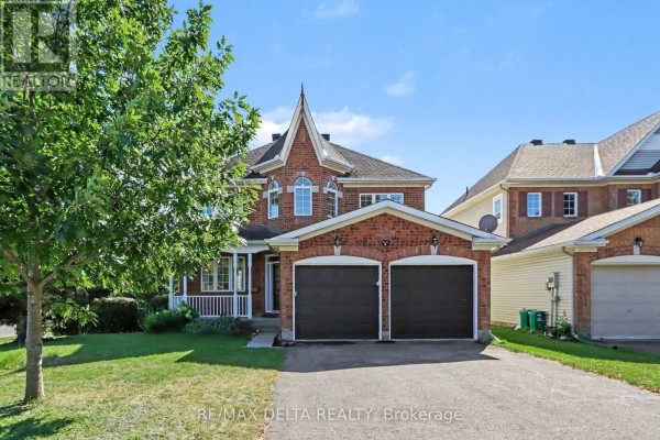 Two-story brick house with arched windows, a pointed roof, and attached garage. - 1 Cheltonia Way, Ottawa