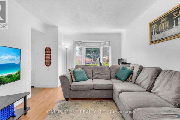 Living room with a bay window, sectional sofa, and wall art. - 1 Cheswick Circle, London South