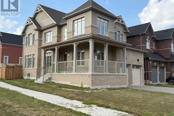 Side exterior of a large brick house with a covered porch, showing multiple windows and garage. - 1 Copperhill Heights N, Barrie
