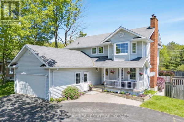 Aerial view of the house, showing the swimming pool and backyard fence, with a road in the background. - 1 Hallen Drive, Penetanguishene