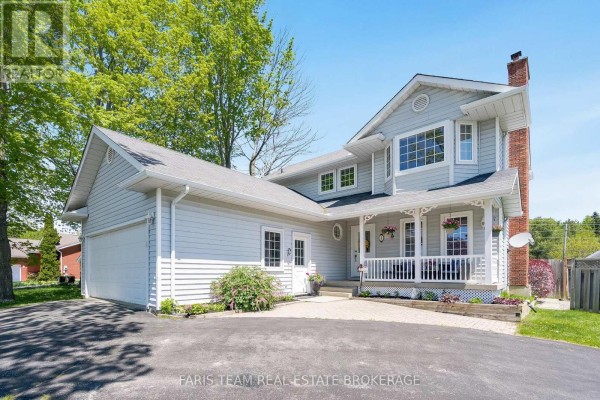 Front exterior of the house with light grey siding, a white garage door, and a covered porch. - 1 Hallen Drive, Penetanguishene