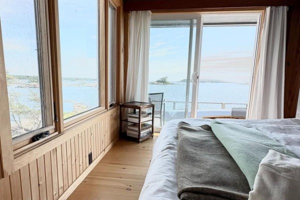 Bedroom with water view, large windows, wood paneling & ceiling - 1 Island 352c Carling