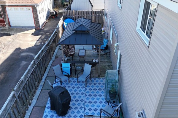 Backyard patio with a covered gazebo, outdoor seating, and a BBQ. - 1 Joubin Rd, Elliot Lake