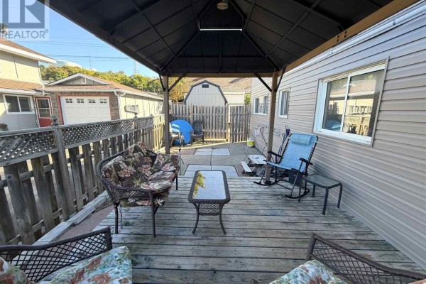 Deck area with seating, a gazebo, and a view of the backyard and garage. - 1 Joubin Rd, Elliot Lake