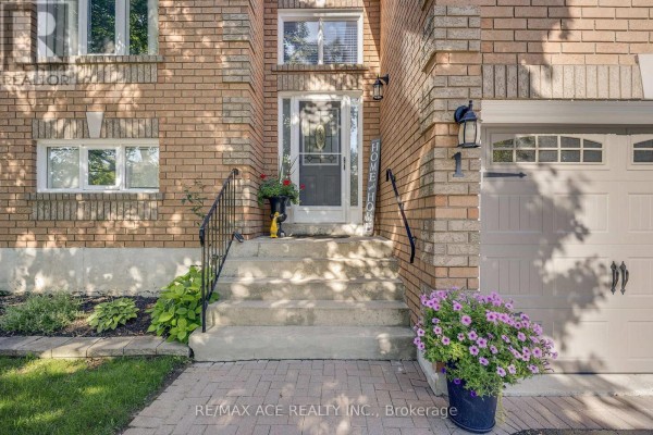 Close-up of the front entrance stairs and door of a brick house with flowers. - 1 Margaret Place, Georgina