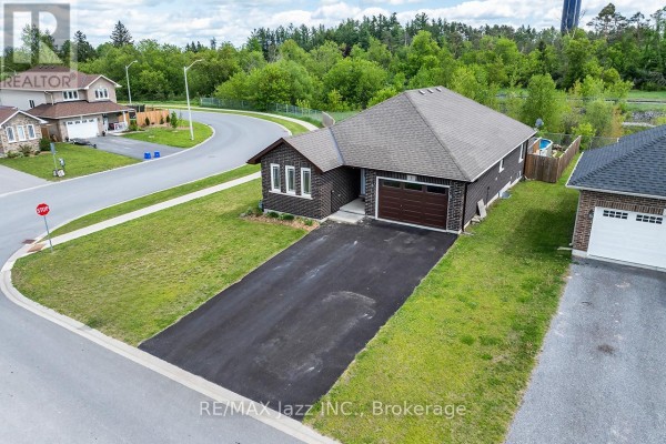 A living room with a sofa, coffee table, armchair, dining area, and kitchen with an island. - 1 Millpond Lane, Asphodel Norwood