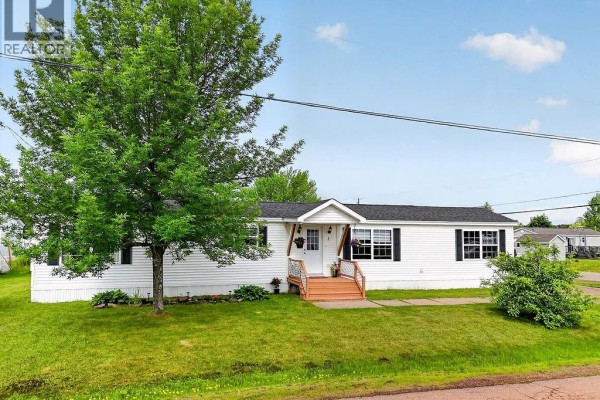 Front of white modular home with porch and landscaping. - 1 Peridot, Moncton