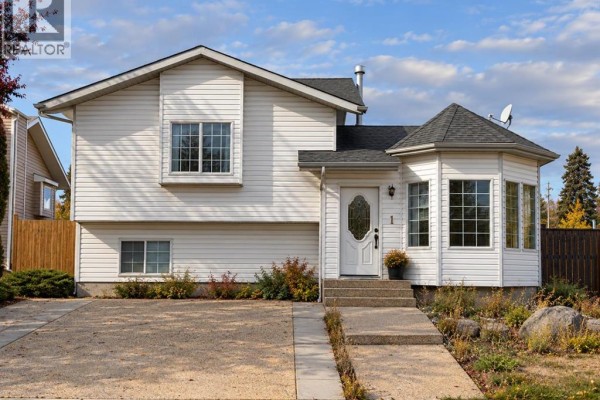 Front exterior of the house with a white door and bay windows on the right side. - 1 Pickering Close, Sylvan Lake