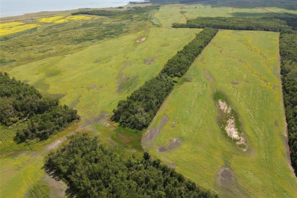 Aerial view of cleared land bordered by forest, with Lake Manitoba Narrows in background. - 1 Reykjavik Road, Lake Manitoba Narrows