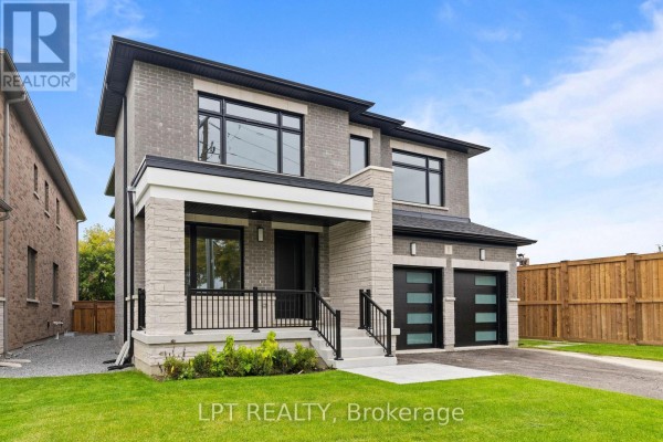 Front exterior of a modern two-story house with grey brick and stone. - 1 Richmond Park Drive, Georgina