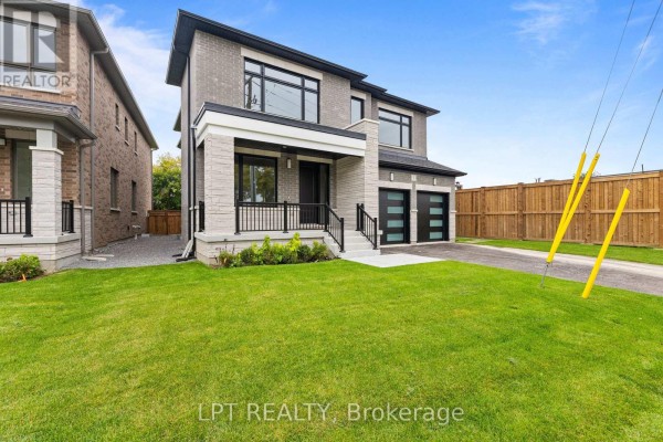 Wide view of the front of a modern two-story house with a manicured lawn. - 1 Richmond Park Drive, Georgina