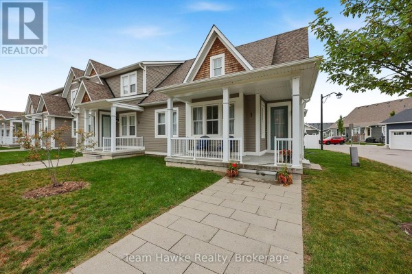 Exterior of townhouses with covered porches and paved walkways. - 1 Samantha Lane, Midland