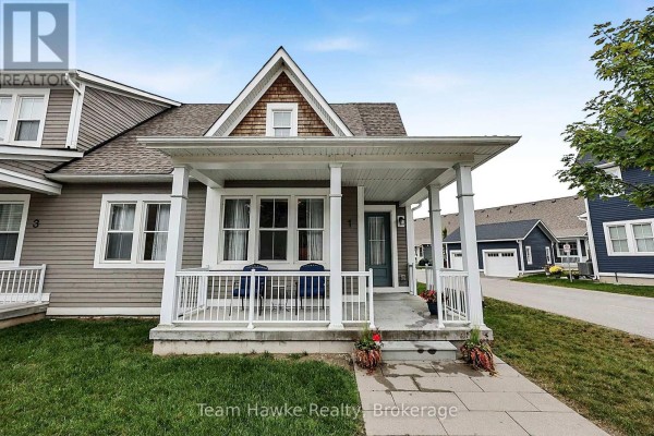 Close-up of a townhouse entrance with a covered porch and two chairs. - 1 Samantha Lane, Midland