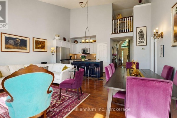 Open concept living space with vaulted ceilings, kitchen island, and lofted railing. - 1 Sierra Trail, Collingwood