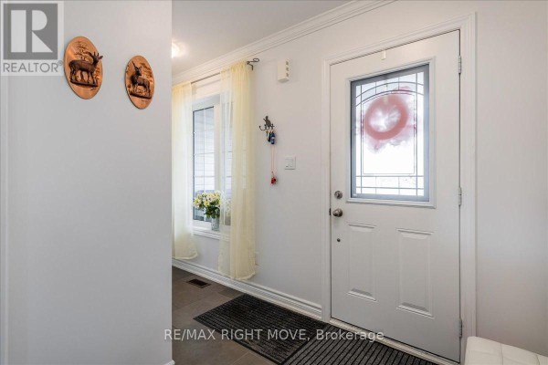 Interior entrance foyer with a white front door and a window with sheer curtains. - 1 Sinclair Crescent, Ramara