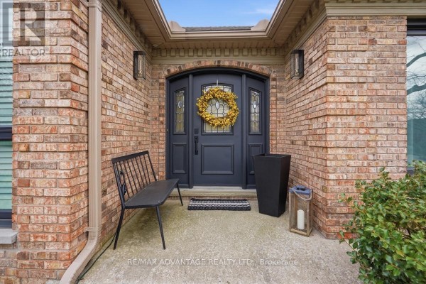 Interior foyer with wood floors, dark dresser, chairs, and colorful rugs. - 1 Smallman Drive, London North