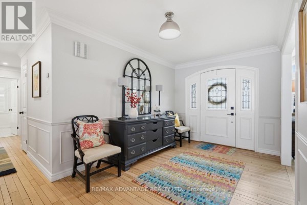 Foyer looking into dining room through glass doors with wood floors. - 1 Smallman Drive, London North