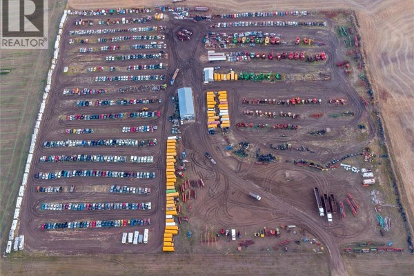 Aerial view of a farm and ranch yard with organized rows of vehicles and equipment, a main building, and surrounding fields. - 1 Tindall Land, Brokenshell Rm No  68
