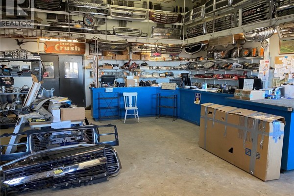 Interior view of a parts department with shelves stocked with car grilles, headlights, and other automotive parts. - 1 Tindall Land, Brokenshell Rm No  68