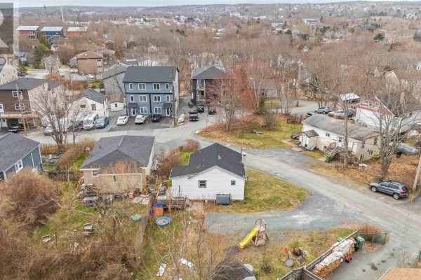 Aerial view of houses and apartment buildings on a street with trees and overcast sky. - 1 Trelyn Road, Halifax