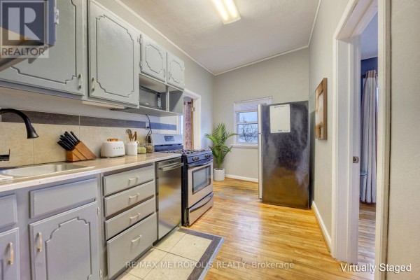 Kitchen with gray cabinets, stainless steel appliances, and wooden flooring - #1 Upper - 1548 St. Clair Parkway, St  Clair