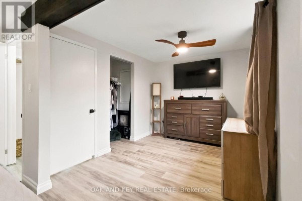 Bedroom with ceiling fan, mounted TV, and dresser - 1 Vanier Place St  Thomas