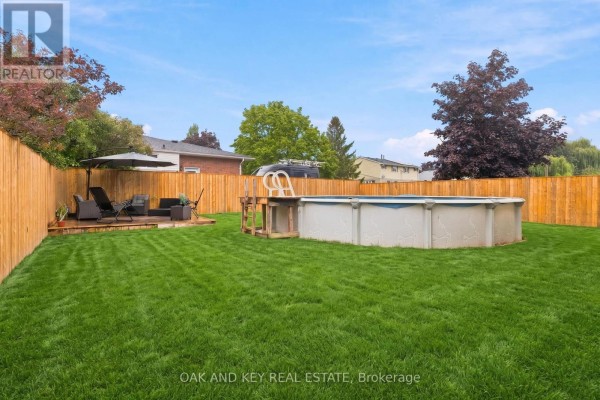 Backyard with pool, deck, and lawn furniture - 1 Vanier Place St Thomas
