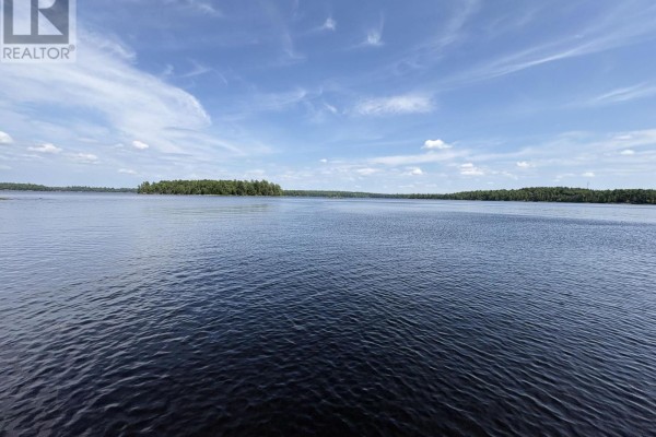 Expansive view of dark blue Lake Wahwashkesh under a bright blue sky with scattered clouds. - 1 W/a Lake Wahwashkesh, Whitestone