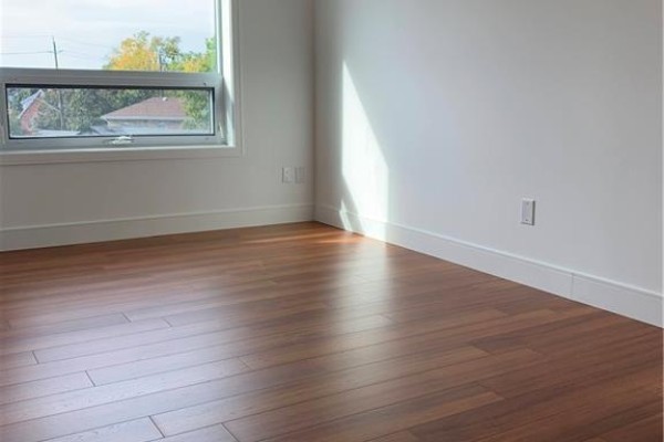 Open concept living area with kitchenette and wood flooring. - 1 Wellington Street Unit# 308, Brantford