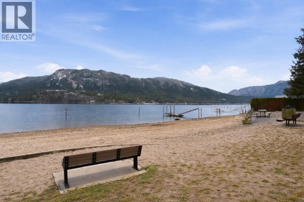 View of trees and mountains from the property, with a glimpse of the lake. - 1 Wolfe Street, Sicamous