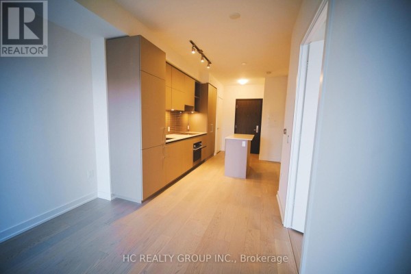 View of a modern kitchen with taupe cabinetry and stainless steel appliances. - 4512 - 1 Yorkville Avenue, Toronto