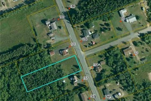 Aerial view of a property lot outlined in blue, surrounded by trees and neighboring houses. - 1.02 Acres Ch Godin, Saumarez