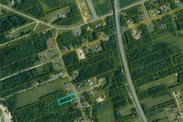 Aerial map showing a property lot outlined in blue amidst a wooded area and roads. - 1.02 Acres Ch Godin, Saumarez
