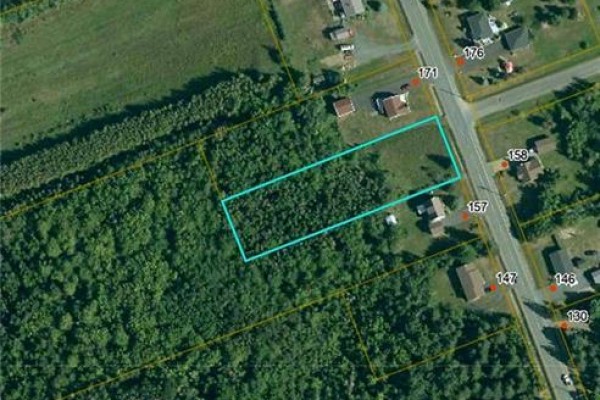 Aerial view of a rectangular lot outlined in blue, adjacent to a road with numbered properties. - 1.02 Acres Ch Godin, Saumarez
