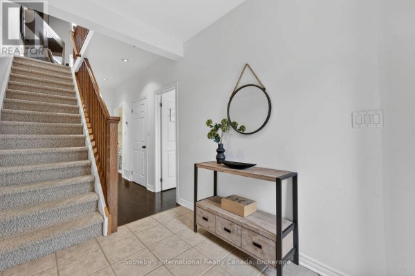 Foyer with a staircase, console table, and round mirror on the wall. - 10 - 110 Kellie's Way, Blue Mountains