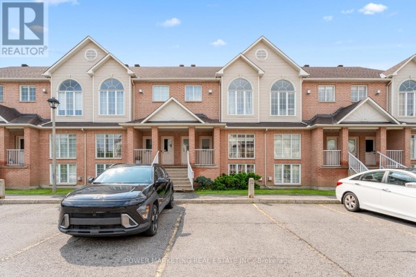 Close-up of the entrance with stairs, greenery, and brick exterior. - 10 - 1701 Blohm Drive, Ottawa