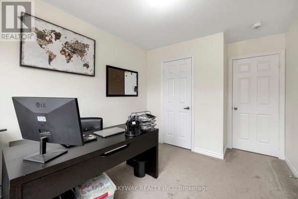 Modern office with desk, computer, carpet, and two doors - 10 - 200 Veterans Drive, Brampton