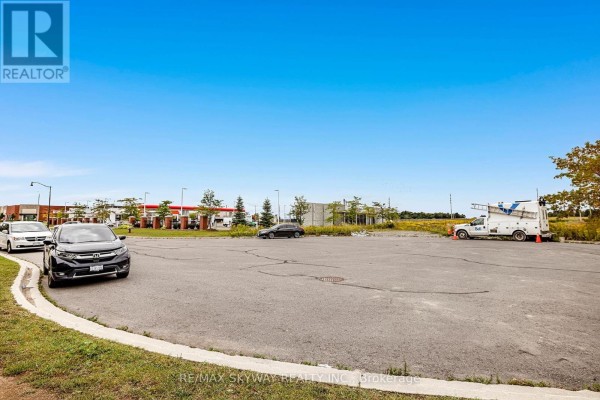 Commercial parking lot with gas station, vehicles, and utility truck - 10 - 200 Veterans Drive, Brampton