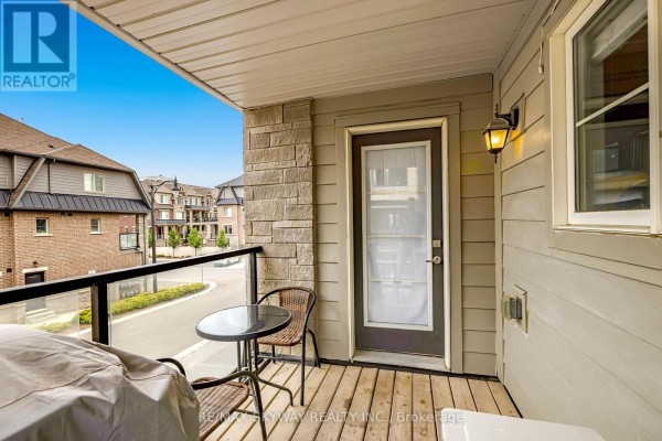 Deck with glass railing, outdoor table, and grill - 10 - 200 Veterans Drive, Brampton