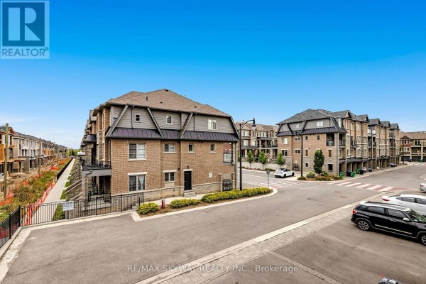 New brick residential buildings with balconies and street view - 10 - 200 Veterans Drive Brampton