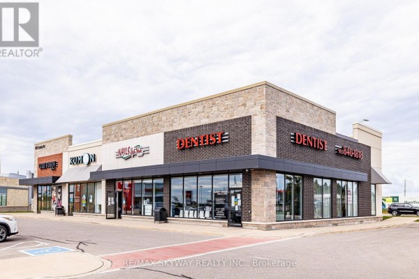 Modern commercial plaza with stone and brick facade, large windows, and parking lot - 10 - 200 Veterans Drive, Brampton