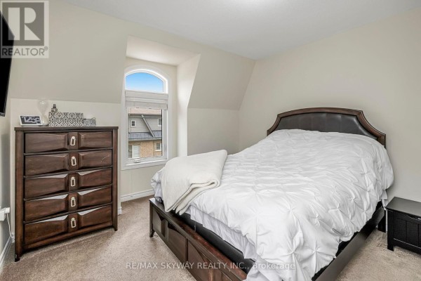 Bedroom with arched window and sloped ceiling - 10 - 200 Veterans Drive, Brampton