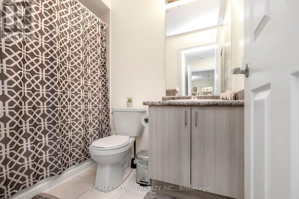 Modern bathroom with vanity, granite counter, shower - 10 - 200 Veterans Drive Brampton