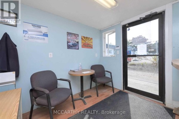 Interior waiting area with two chairs, a small table, and a glass door. - 10 - 226 First Avenue E, Shelburne