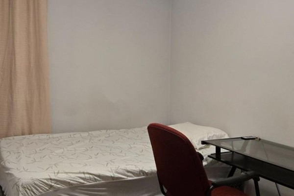 Bedroom with a single mattress, desk, chair, and light beige curtains. - 10 - 242 Penetanguishene Road, Barrie