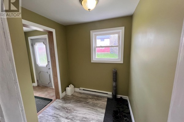 Interior entryway with pale green walls, a window, and a grey paneled door visible. - 10-12 Hill Avenue, Clarkes Beach