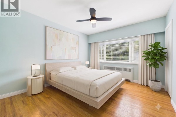 Bedroom with a modern bed, nightstand, ceiling fan, and wood floors. - 10 2296 W 39th Avenue, Vancouver